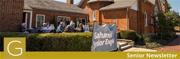 Senior Expo sign with attendees sitting on a patio