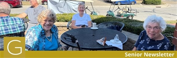Photo of three senior center members sitting on a patio table at the Senior Expo smiling
