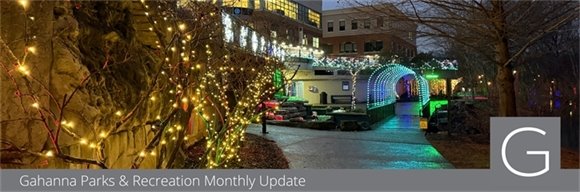 Creekside Plaza lit up with holiday lights at night