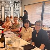 Four senior center members sitting together at a restaurant table