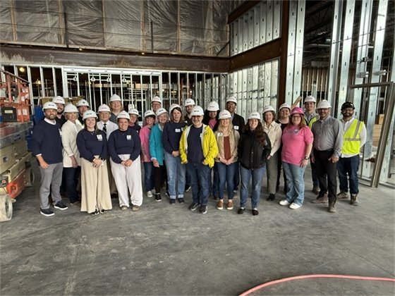 Group of Citizens Academy members and City Staff smiling in the new Civic Center Building