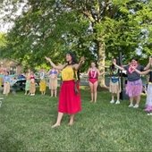 Luau Night at the pool with a crowd learning a dance