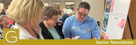 Three women looking at a paper together during the Vision Festival Senior Lunch