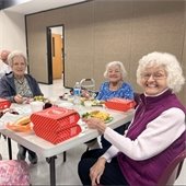 Gahanna senior center residents sharing a meal together and smiling for the camera