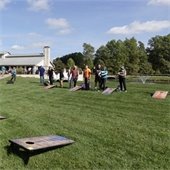 a group of people playing cornhole together
