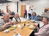 Senior Center members having lunch at a table together