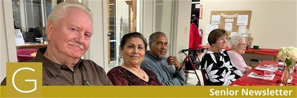 three senior center members sitting together at a table with a red tablecloth