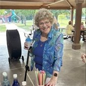 A senior center member holding shaved ice