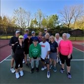A group of residents on a pickleball court