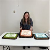 Devon standing with three cakes that read "dessert with devon"