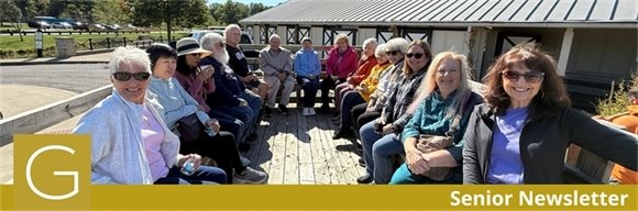A group of senior center members on a hayride on a sunny day