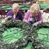 two senior center members working on decorating 