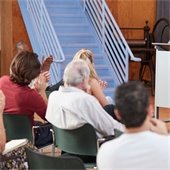 Senior Center members sitting in chairs in a meeting
