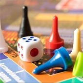 A board game with dice and colorful player pieces