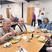 Senior Center members having lunch at a table together