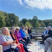 A groups of senior center members enjoying a hayride on a sunny day at the Fall Fireside Feast