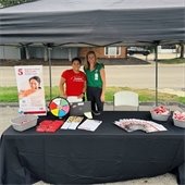 two women and booth at health fair