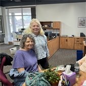 Two senior center members standing together smiling