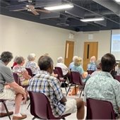 A room full of senior center members listening to a presentation