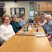 A table of senior center members enjoying a game of morning bingo