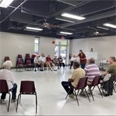 a room full of senior center members playing beanbag baseball