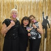 Senior Center members with props in a photobooth