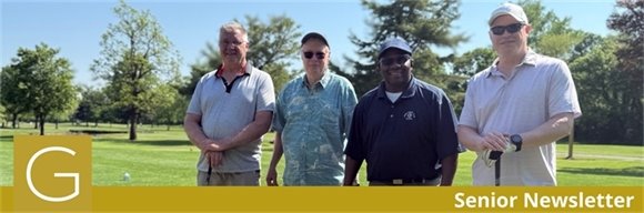 Four senior center golf league members standing together on the golf course on a sunny day