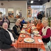 A table full of senior center members enjoying a Thanksgiving meal together