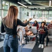 Group coaching session with speaker talking to the class