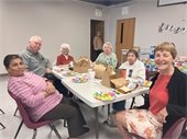 Senior Center members sitting together at a table for a birthday celebration