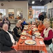 senior center members sharing a thanksgiving meal together at a table