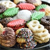 A plate full of a variety of holiday decorated cookies