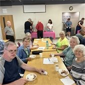 Senior Center members having ice cream at a table together and smiling