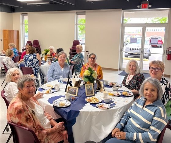 A table full of senior center members having tea for mother's day brunch
