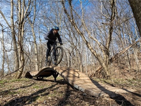 A man riding on the mountain bike trail during the winter.