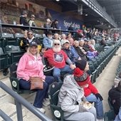A group of senior center members sitting together at a Cleveland Guardians game