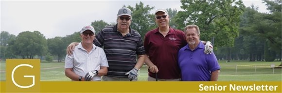A photo of four senior golf league members on the green