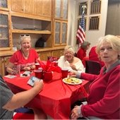 three senior center members sharing a meal together at a table