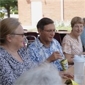 Senior citizens sitting and talking at a table