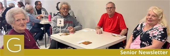 Gahanna Senior Center residents sitting at a table playing euchre and smiling