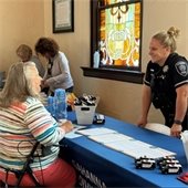 An attendee and Police Officer smiling at the Senior Expo