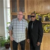 Two senior center members posing in front of a Let's Boogie sign