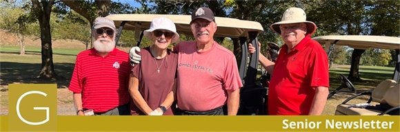 Four senior center members wearing red and smiling together on the golf course