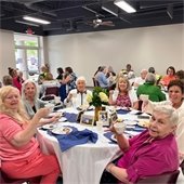 senior center members sitting at a table having lunch together
