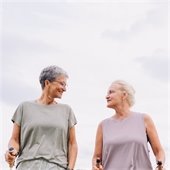 A photo of two senior women on a walk on an overcast day