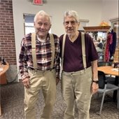 Two senior center members standing together and smiling