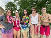 A group of teens at the pool smiling for the camera