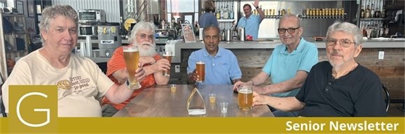 Senior center members sitting at a table and having a beer together for Father's Day