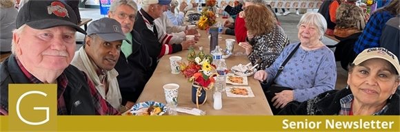 A table full of senior center members sharing a meal together for 2024 Fall Fireside Feast