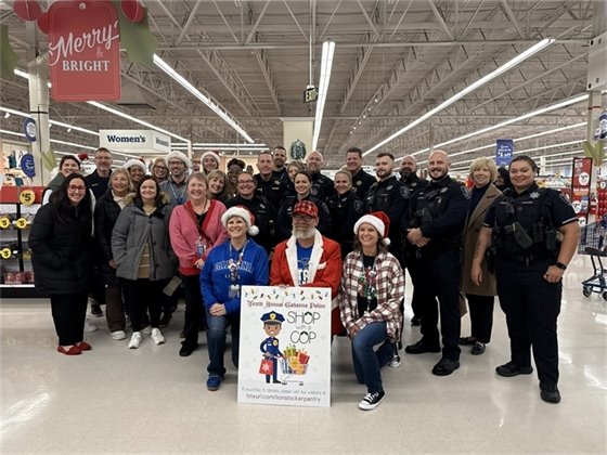 The Division of Police, Mayor Jadwin, and GJPS staff smiling together for Shop with a Cop